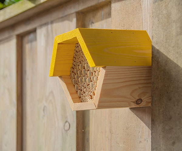 Hanging on fence Hexagonal Shaped Bee Nesting House www.wingandhive.com